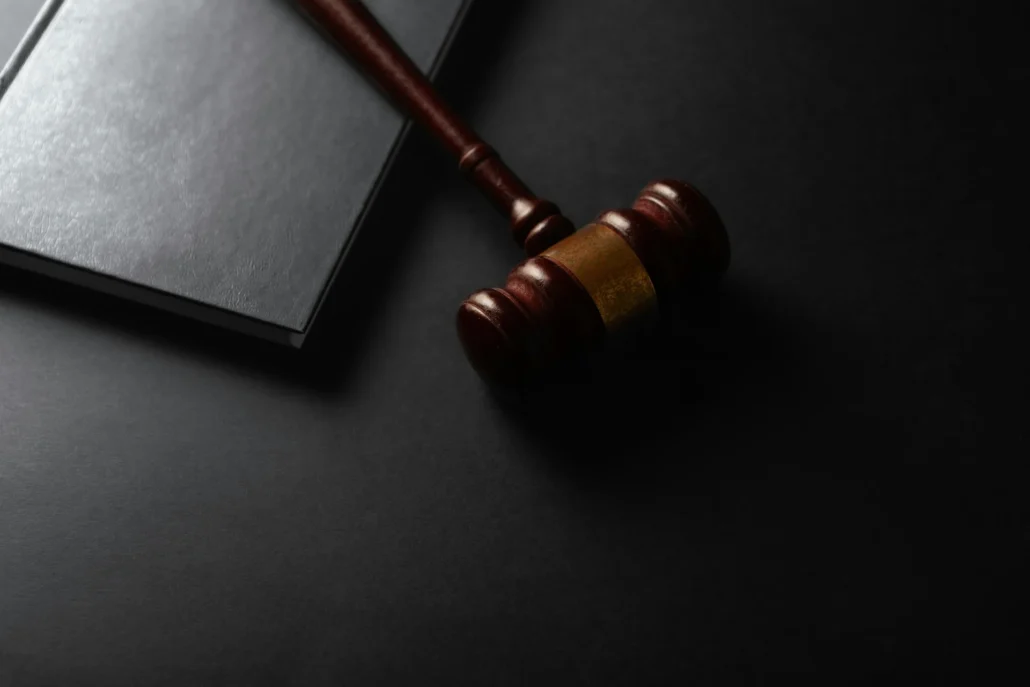 Judge gavel and law book on dark background — are poppers drugs classification